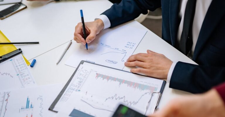 Professionals analyzing financial charts in a corporate setting.
